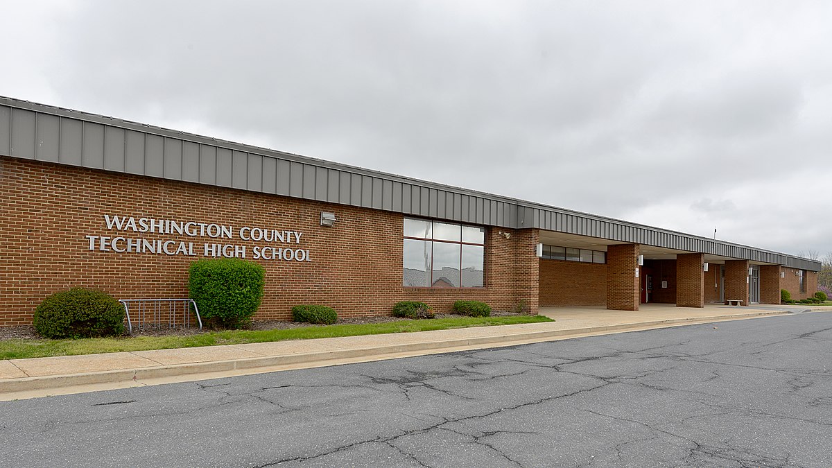 The image shows the exterior of Washington County Technical High School, a single-story brick building under an overcast sky.